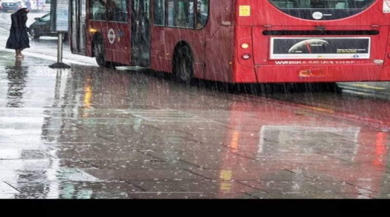 Heavy rain on city street with red bus and water reflection
